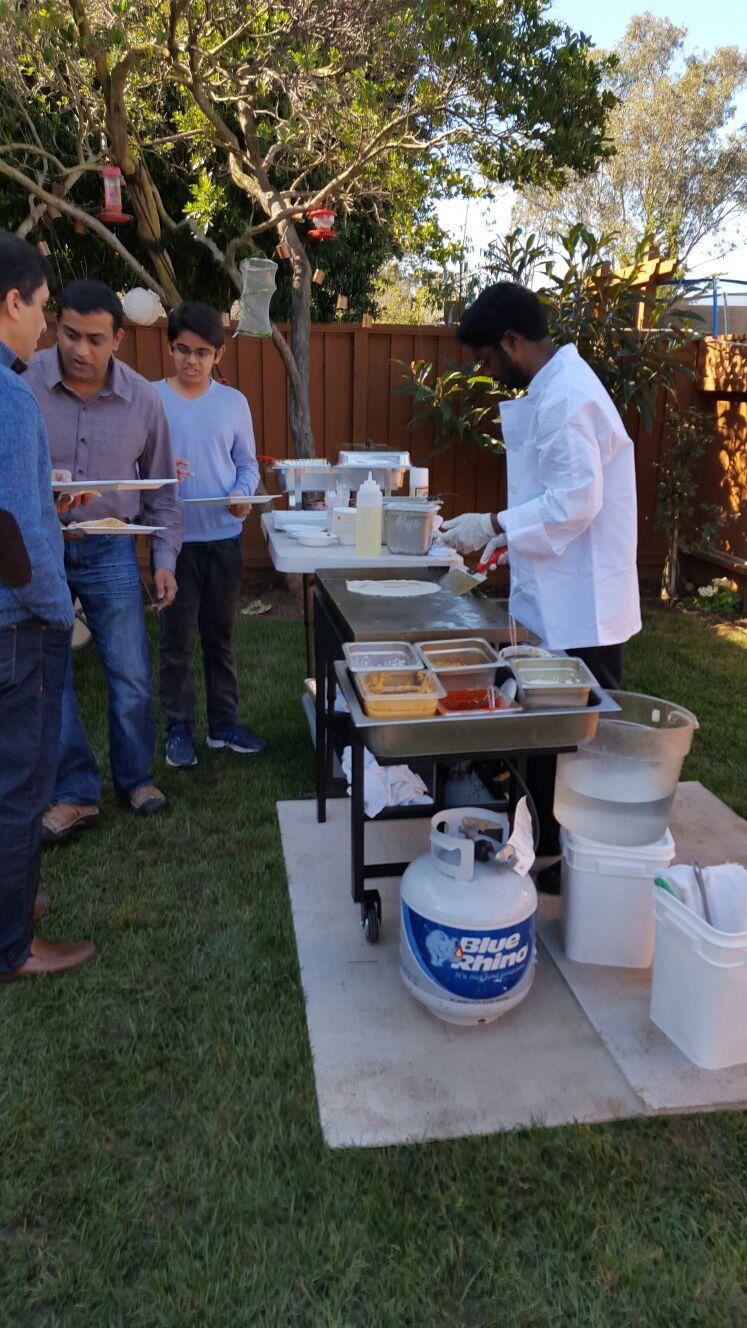 Guests watching the chef at an on-site live dosa station